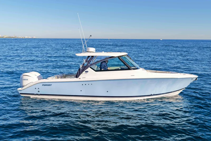 Slide: The Image of 2023 Pursuit DC 295 Dual Console boat cruising on open water. - 39
