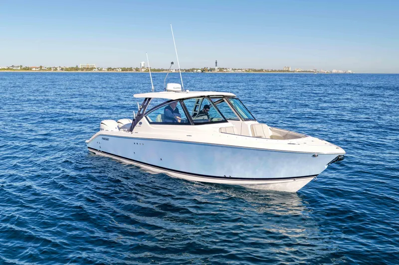 Slide: The Image of 2023 Pursuit DC 295 Dual Console boat cruising on open water. - 40