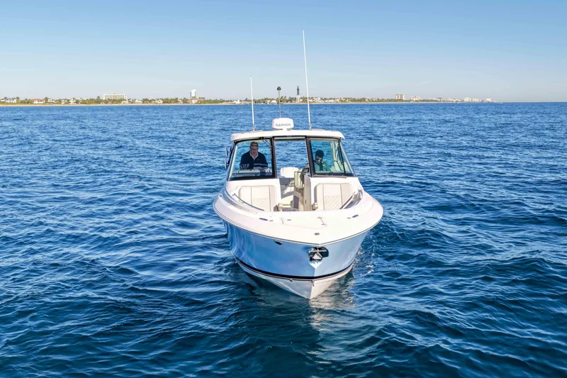 Slide: The Image of 2023 Pursuit DC 295 Dual Console boat cruising on open water. - 43