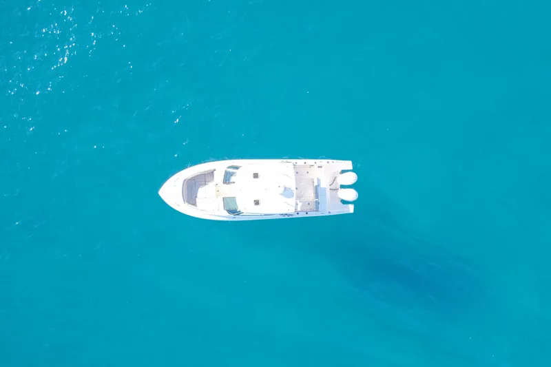 Slide: The Image of Aerial view of 2023 Pursuit DC 295 Dual Console boat on clear blue water. - 48