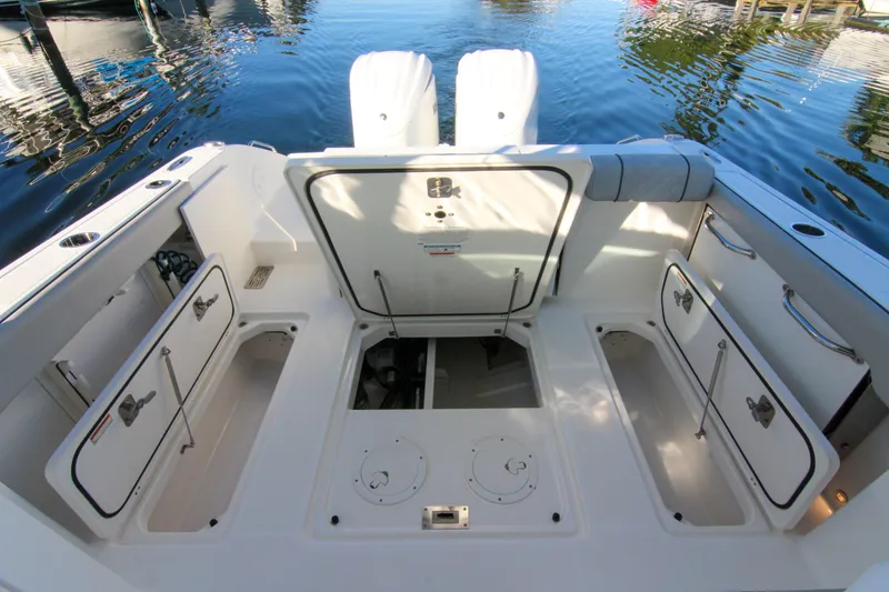 Slide: The Image of 2023 Pursuit DC 295 Dual Console boat interior with open storage compartments. - 5