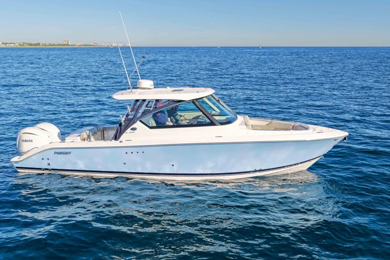 Slide: The Image of 2023 Pursuit DC 295 Dual Console boat cruising on open blue water. - 52
