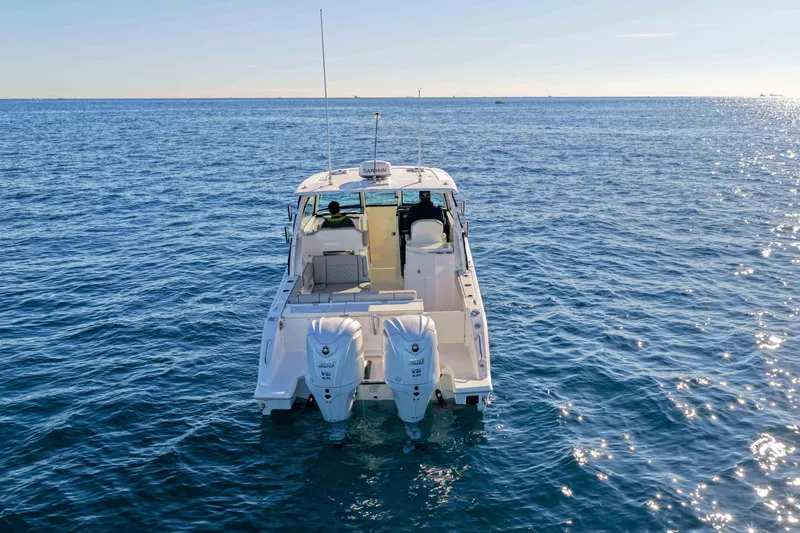 Slide: The Image of 2023 Pursuit DC 295 Dual Console boat on open water, rear view. - 54