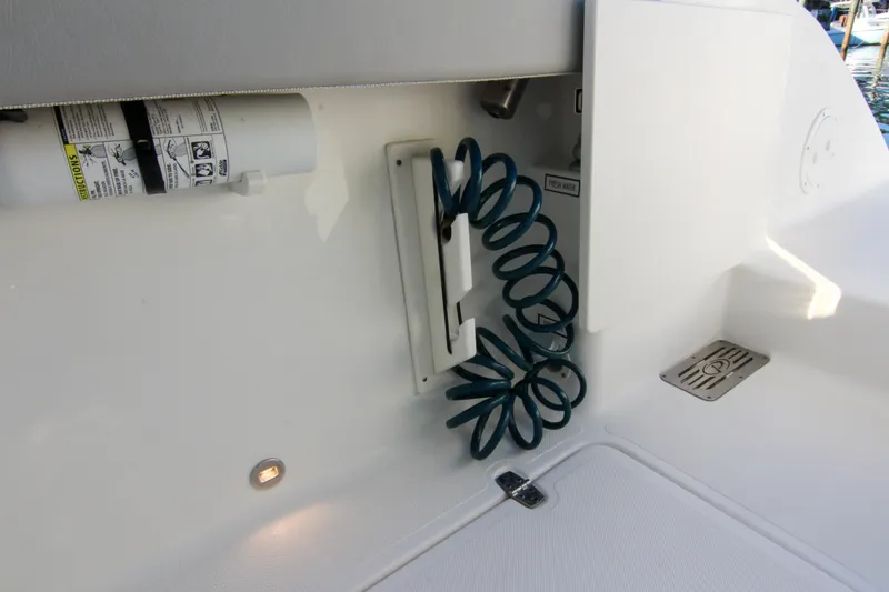 Slide: The Image of 2023 Pursuit DC 295 Dual Console boat with coiled hose and fire extinguisher. - 7