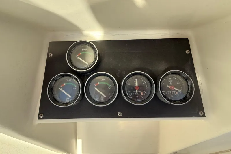 Slide: The Image of Dashboard gauges of a 1988 Phoenix 29 SFX Convertible boat. - 12