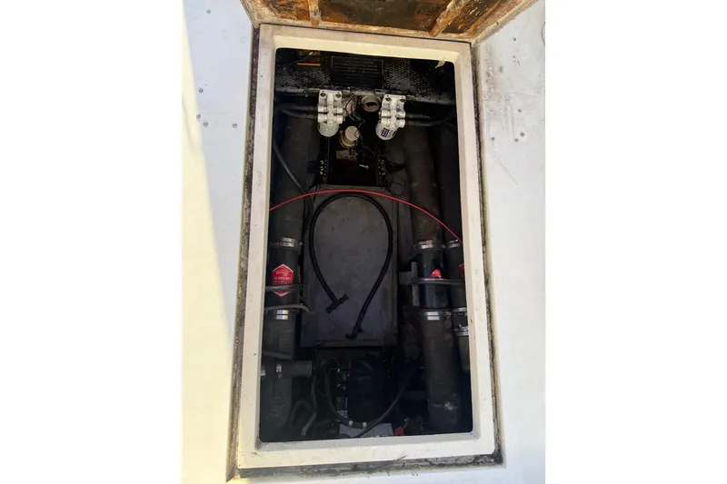 Slide: The Image of Engine compartment of a 1988 Phoenix 29 SFX Convertible boat, showing mechanical components. - 18