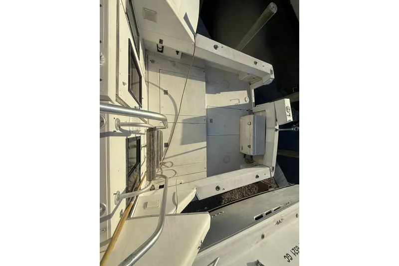 Slide: The Image of 1988 Phoenix 29 SFX Convertible boat deck with railing and storage compartments. - 3