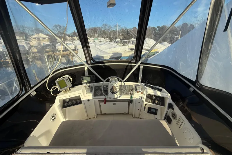 Slide: The Image of 1988 Phoenix 29 SFX Convertible boat cockpit with steering wheel and navigation equipment. - 7