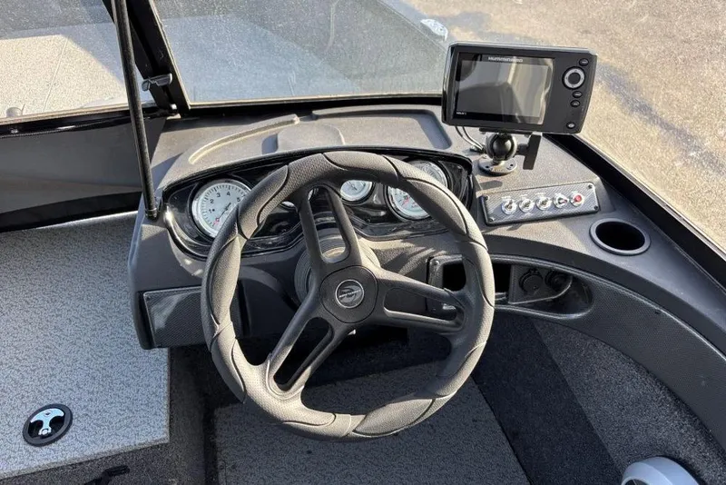 Slide: The Image of 2024 Crestliner 1650 Hawk boat dashboard with steering wheel and navigation system. - 4