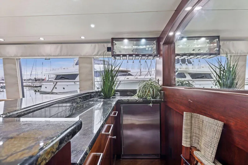 Slide: The Image of Luxurious interior of 1998 Pacific Mariner 65 yacht with elegant bar and marina view. - 11