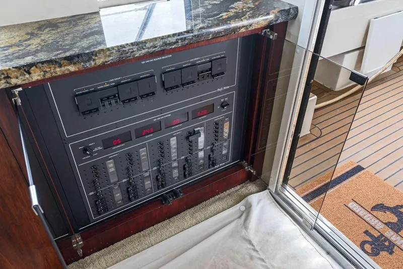 Slide: The Image of Electrical panel on a 1998 Pacific Mariner 65 yacht with granite countertop. - 14