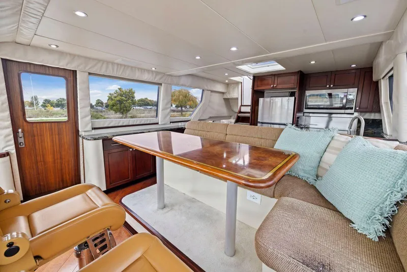 Slide: The Image of Luxurious interior of a 1998 Pacific Mariner 65 yacht with elegant dining area and modern kitchen. - 23