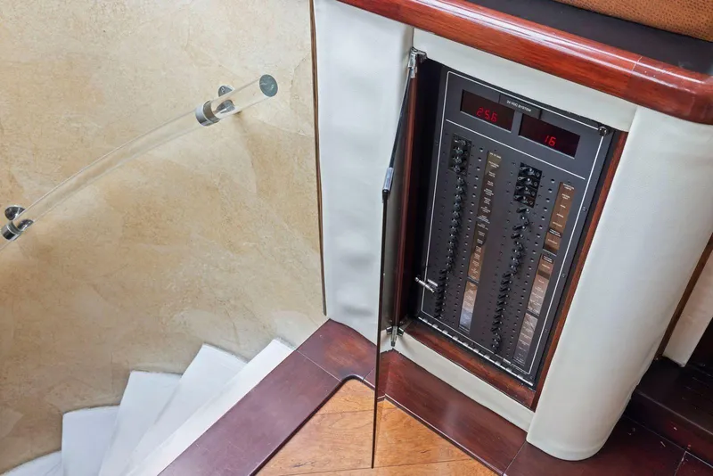 Slide: The Image of Electrical panel on 1998 Pacific Mariner 65 yacht, near wooden staircase. - 27