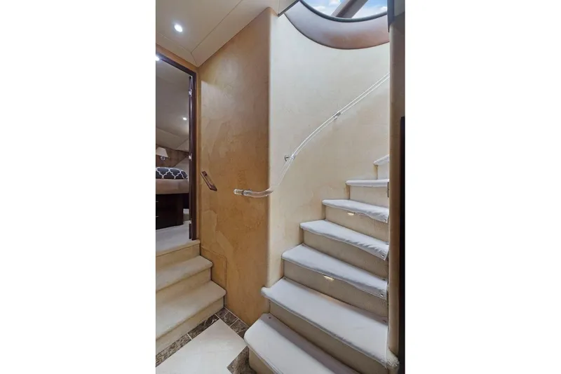 Slide: The Image of Interior staircase of 1998 Pacific Mariner 65 yacht, featuring elegant design and soft lighting. - 30