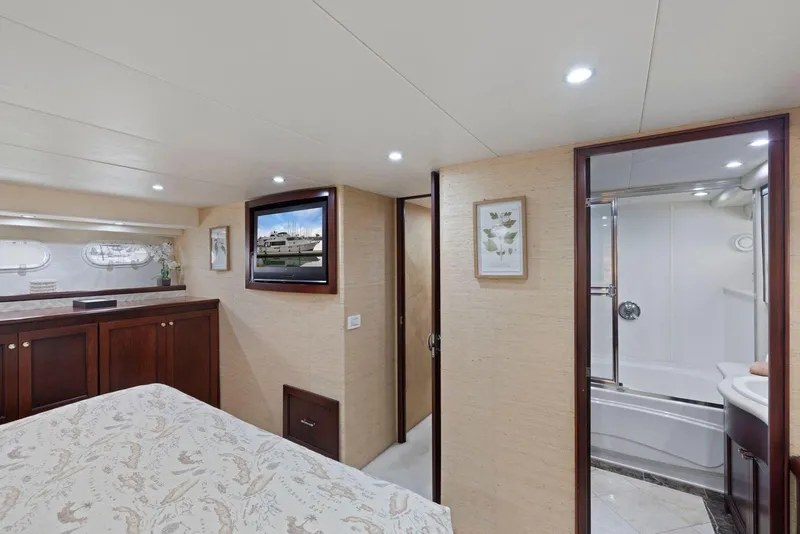 Slide: The Image of Luxurious interior of 1998 Pacific Mariner 65 yacht with elegant wood cabinetry and modern bathroom. - 34