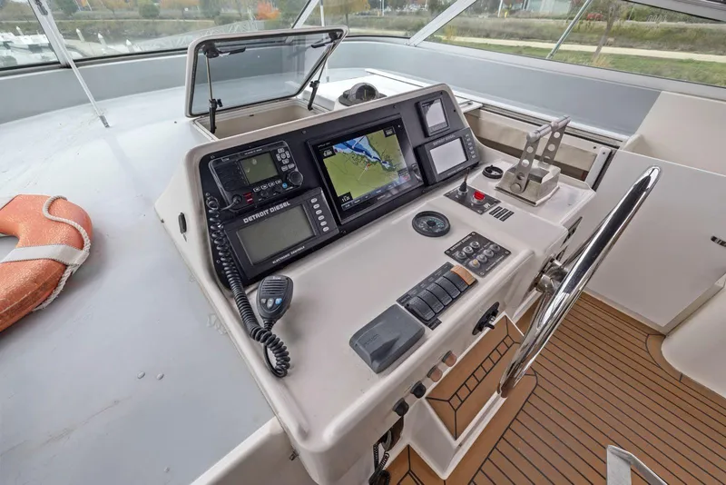 Slide: The Image of Cockpit of 1998 Pacific Mariner 65 yacht with navigation equipment and steering wheel. - 49