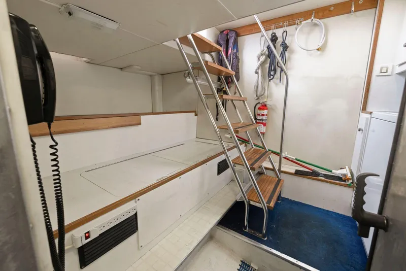 Slide: The Image of Interior of 1998 Pacific Mariner 65 yacht with stairs and storage area. - 65