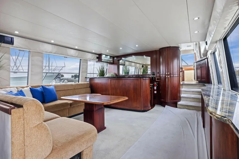 Slide: The Image of Luxurious interior of a 1998 Pacific Mariner 65 yacht with elegant wood finishes and plush seating. - 7