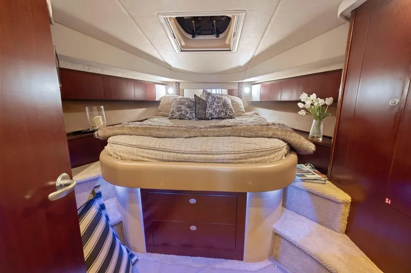Slide: The Image of Luxurious 2005 Sea Ray 420 Sedan Bridge cabin interior with cozy bed and elegant decor. - 12