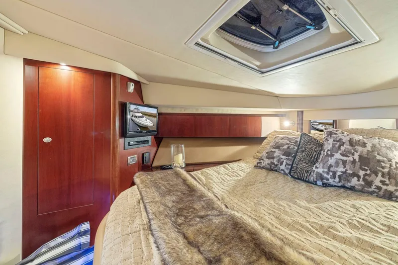 Slide: The Image of Luxurious 2005 Sea Ray 420 Sedan Bridge cabin with elegant bedding and wood accents. - 13