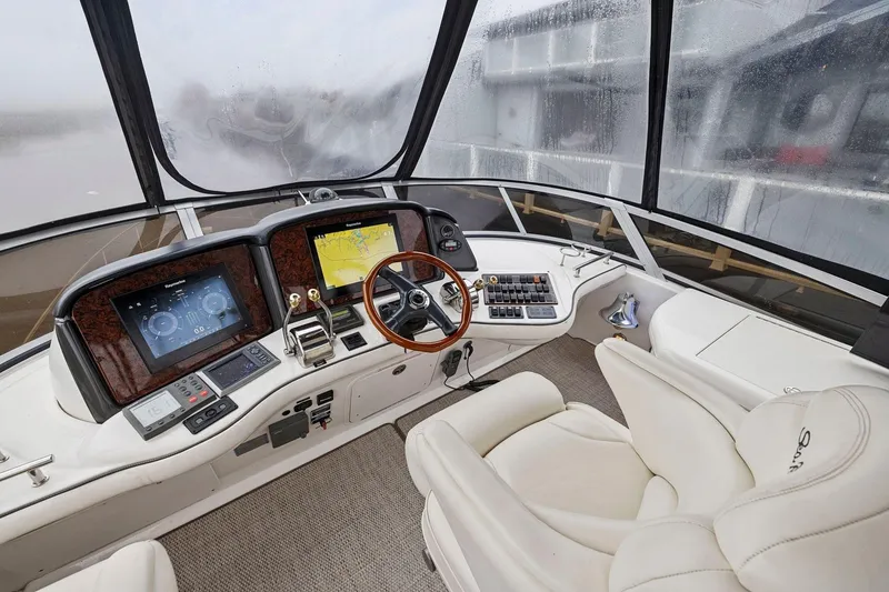 Slide: The Image of 2005 Sea Ray 420 Sedan Bridge helm with modern navigation equipment and luxurious seating. - 18