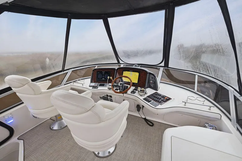 Slide: The Image of Interior helm of 2005 Sea Ray 420 Sedan Bridge with modern navigation equipment. - 19