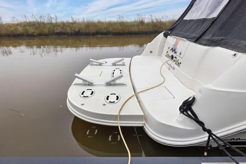 Slide: The Image of 2005 Sea Ray 420 Sedan Bridge yacht docked on calm water. - 2