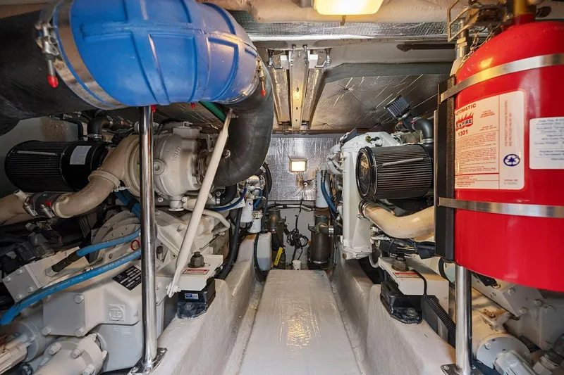 Slide: The Image of Engine room of 2005 Sea Ray 420 Sedan Bridge with visible machinery and fire extinguisher. - 25