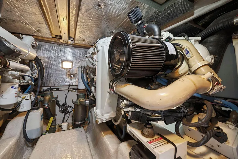 Slide: The Image of Engine room of 2005 Sea Ray 420 Sedan Bridge with visible components and insulation. - 27