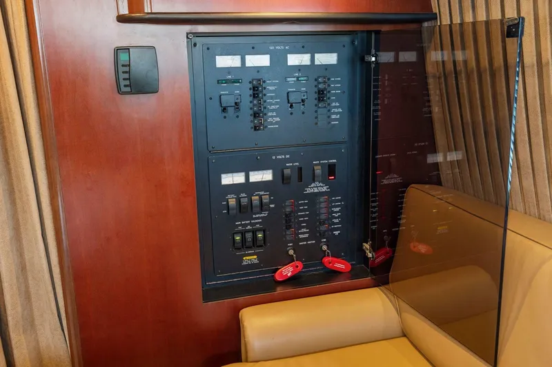 Slide: The Image of Electrical panel on 2005 Sea Ray 420 Sedan Bridge yacht, featuring switches and controls. - 28