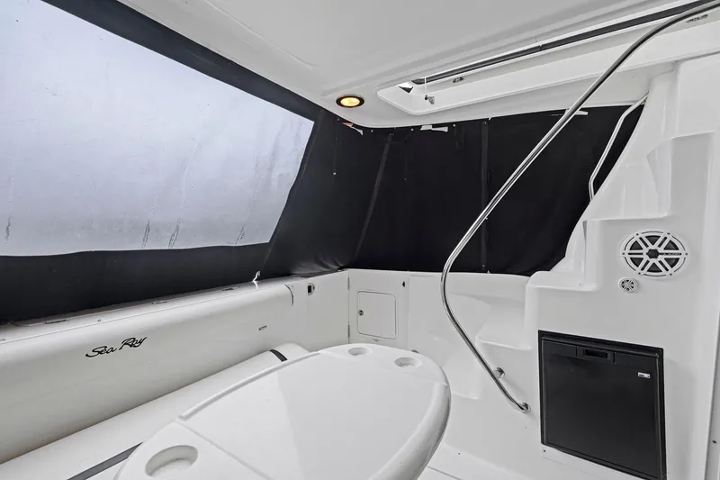 Slide: The Image of 2005 Sea Ray 420 Sedan Bridge interior with seating and black curtains. - 4