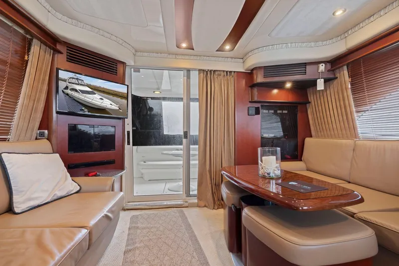 Slide: The Image of Luxurious interior of 2005 Sea Ray 420 Sedan Bridge yacht with elegant seating and decor. - 6