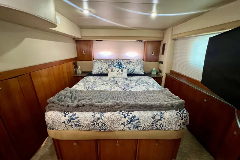 Slide: The Image of Luxurious bedroom interior of 2004 Meridian 408 Motoryacht with cozy bedding and wood accents. - 13