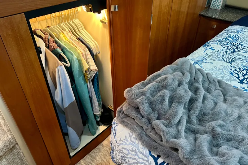 Slide: The Image of Cozy bedroom in 2004 Meridian 408 Motoryacht with open closet and plush bedding. - 15