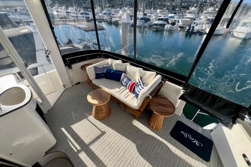 Slide: The Image of Luxurious 2004 Meridian 408 Motoryacht interior with marina view, featuring cozy seating and nautical decor. - 2