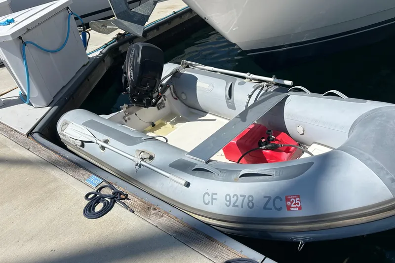Slide: The Image of Inflatable dinghy with outboard motor docked beside a 2004 Meridian 408 Motoryacht. - 21