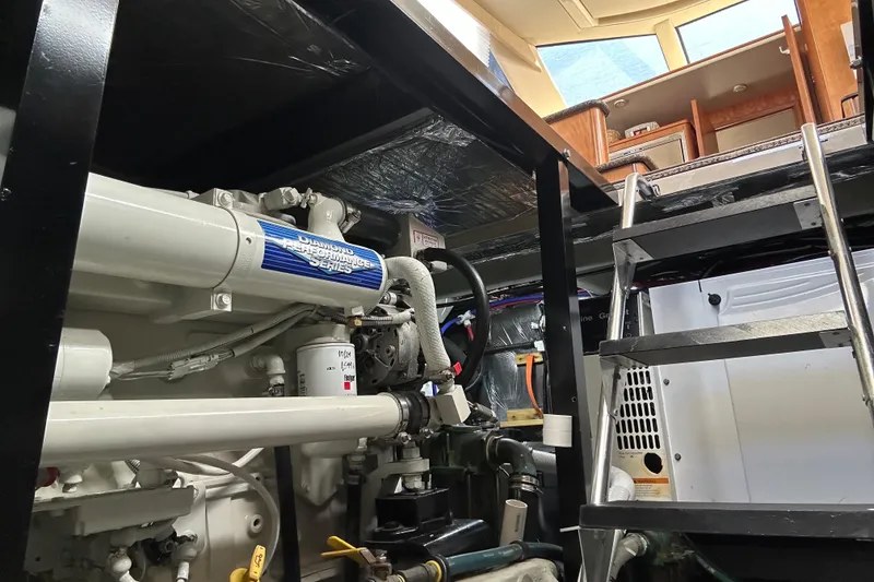 Slide: The Image of Engine room of 2004 Meridian 408 Motoryacht with visible machinery and ladder access. - 23