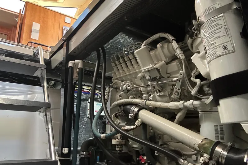 Slide: The Image of Engine room of a 2004 Meridian 408 Motoryacht with visible machinery and ladder. - 24