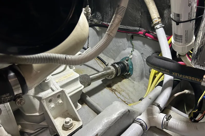 Slide: The Image of Engine compartment of 2004 Meridian 408 Motoryacht with visible hoses and components. - 32