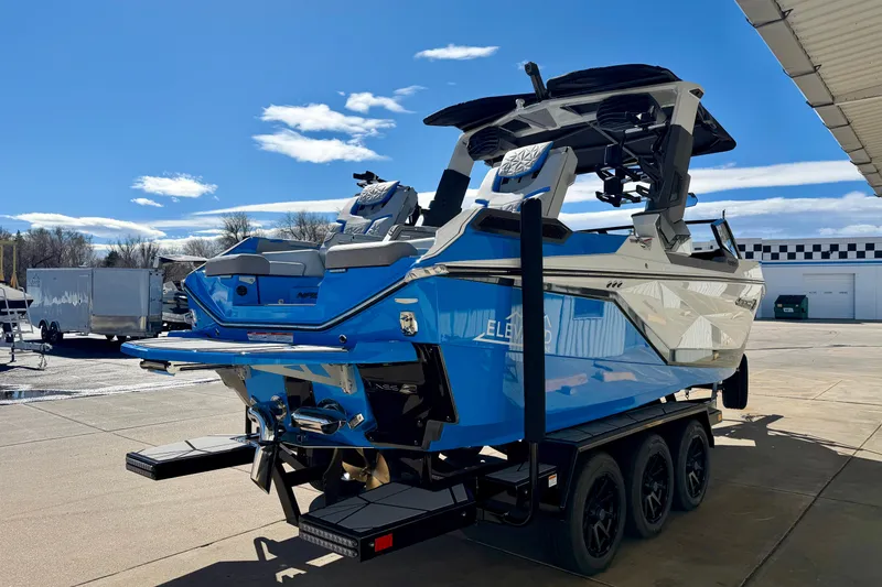 Slide: The Image of 2026 Nautique Super Air Nautique G23 Paragon boat on trailer, blue and white design. - 11