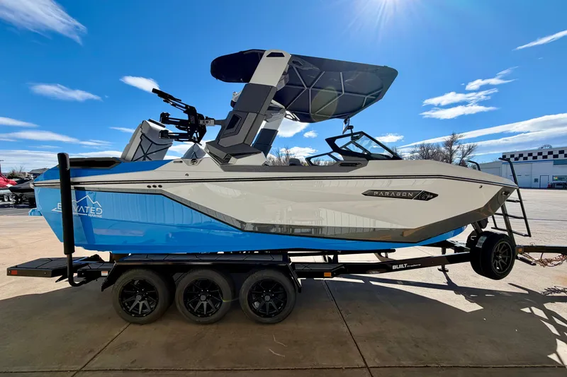 Slide: The Image of 2026 Nautique Super Air Nautique G23 Paragon boat on trailer under blue sky. - 12