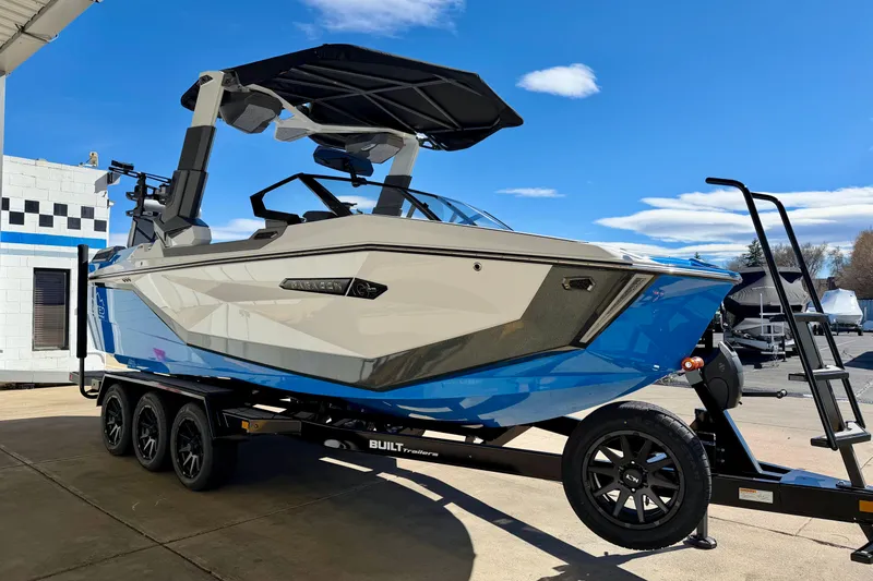 Slide: The Image of 2026 Nautique Super Air Nautique G23 Paragon boat on trailer under blue sky. - 13