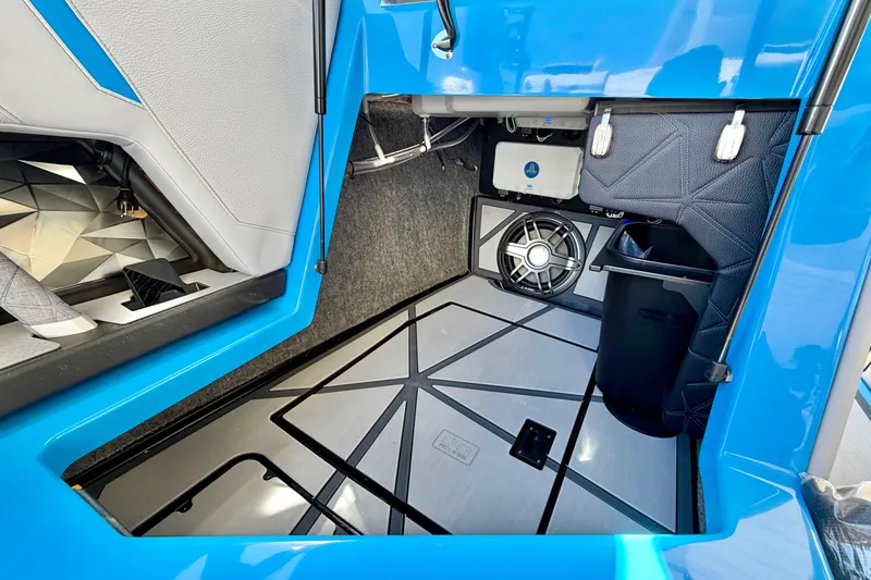 Slide: The Image of Interior view of 2026 Nautique Super Air Nautique G23 Paragon boat, featuring storage and speaker. - 28
