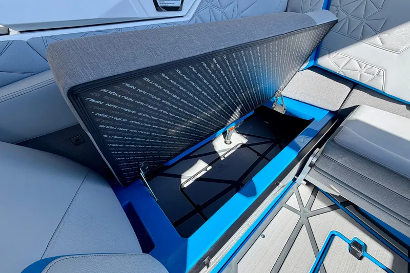 Slide: The Image of 2026 Nautique Super Air Nautique G23 Paragon interior storage compartment with open seat. - 34