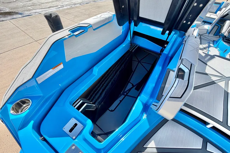 Slide: The Image of 2026 Nautique Super Air Nautique G23 Paragon boat interior storage compartment, blue and gray design. - 42