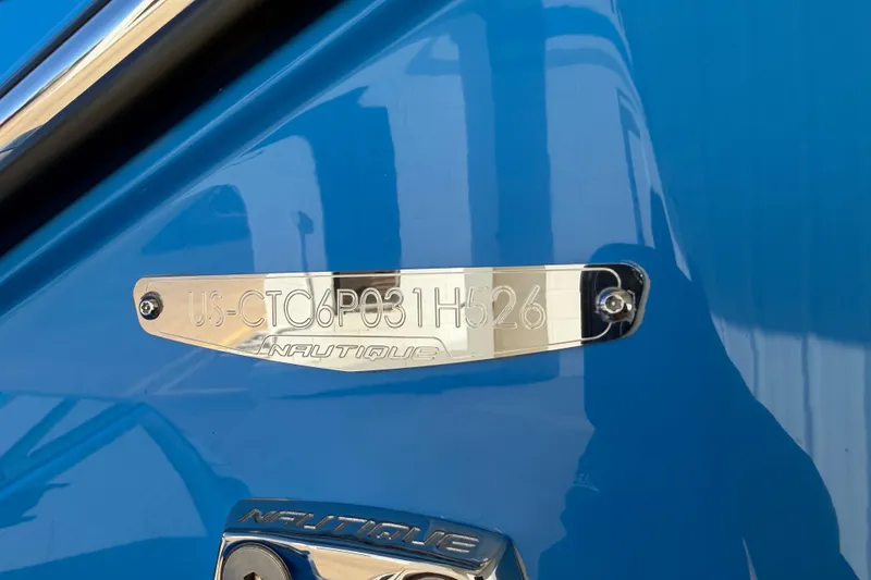 Slide: The Image of 2026 Nautique Super Air Nautique G23 Paragon hull identification plate on blue surface. - 51