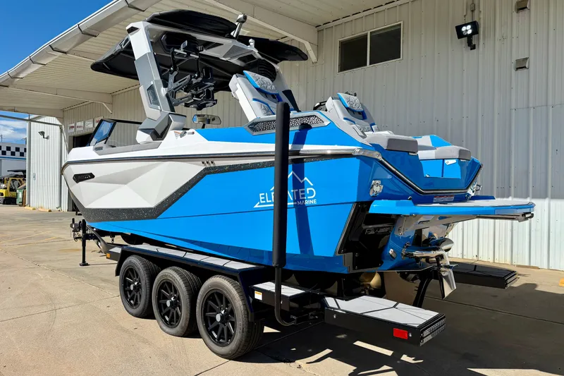 Slide: The Image of 2026 Nautique Super Air Nautique G23 Paragon boat on trailer, blue and white design. - 8
