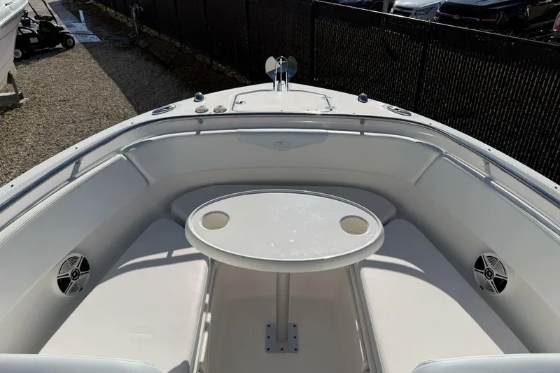 Slide: The Image of 2018 Robalo R247 Dual Console boat with spacious seating and table in the bow area. - 15