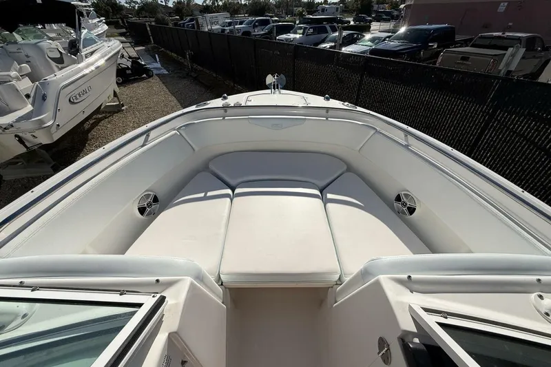 Slide: The Image of 2018 Robalo R247 Dual Console boat with spacious white seating area. - 17