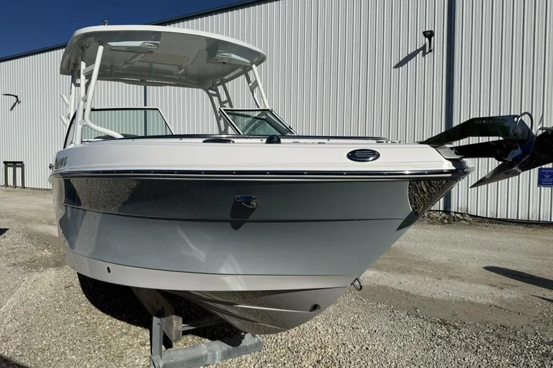 Slide: The Image of 2018 Robalo R247 Dual Console boat displayed outdoors near a large building. - 3